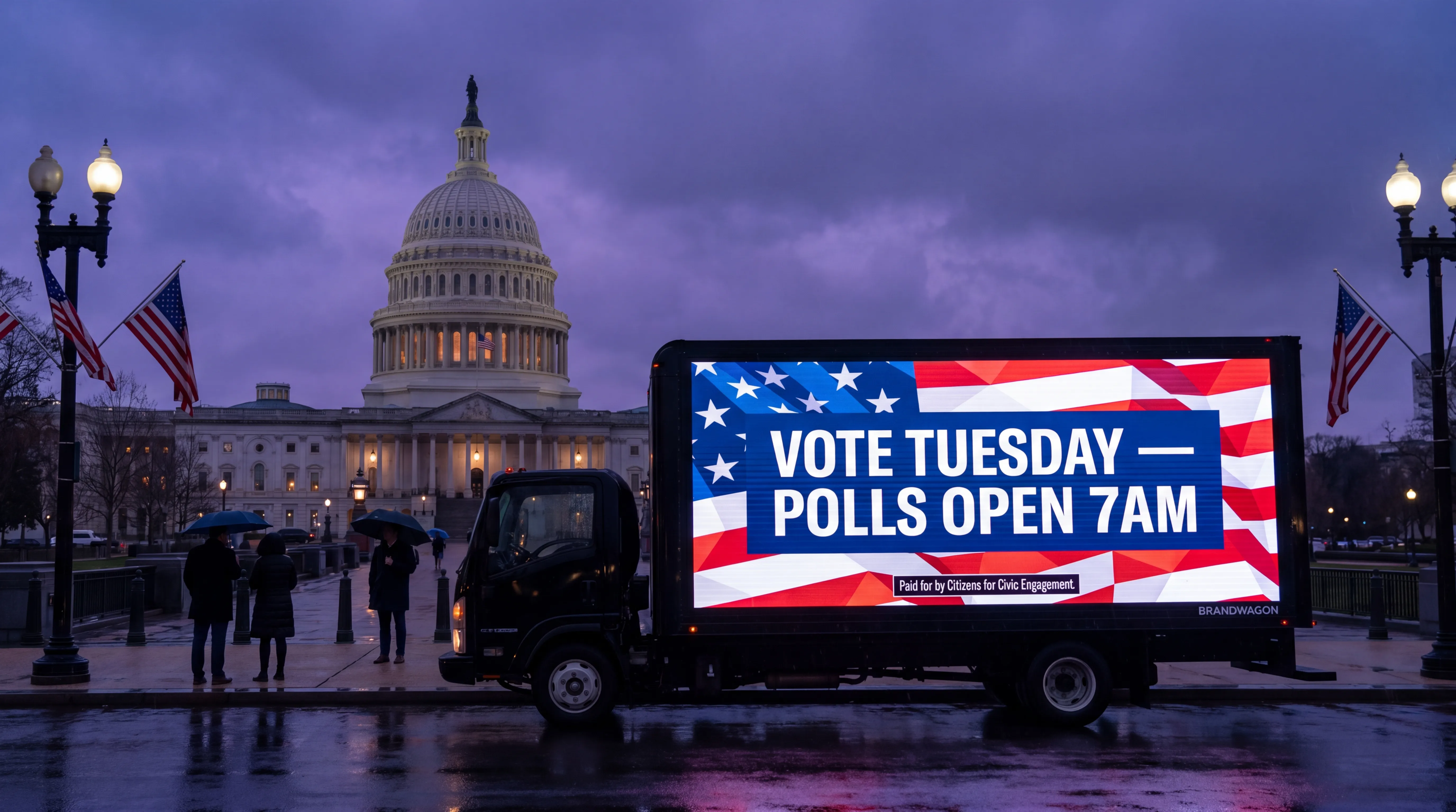Brandwagon LED truck near the US Capitol at dusk under stormy skies, screen displaying a non-partisan VOTE TUESDAY POLLS OPEN 7AM civic engagement ad